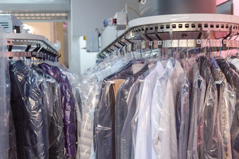 Clean clothes on hangers in the laundry room